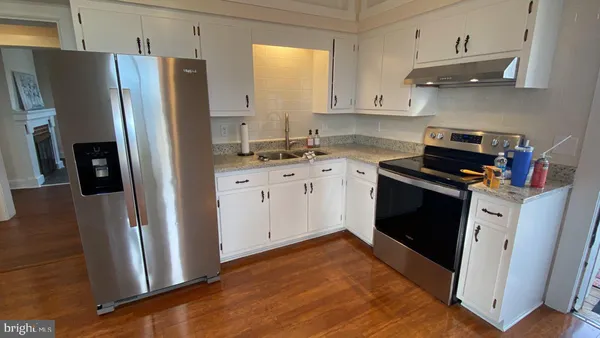 a kitchen with stainless steel appliances a refrigerator stove and sink