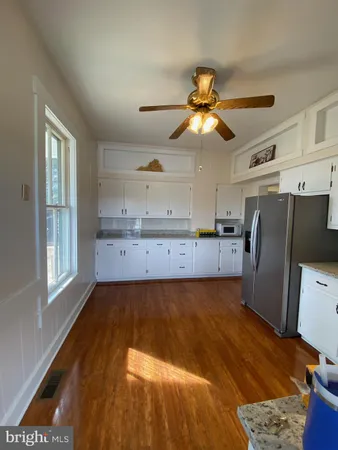 a kitchen with a sink stainless steel appliances and cabinets