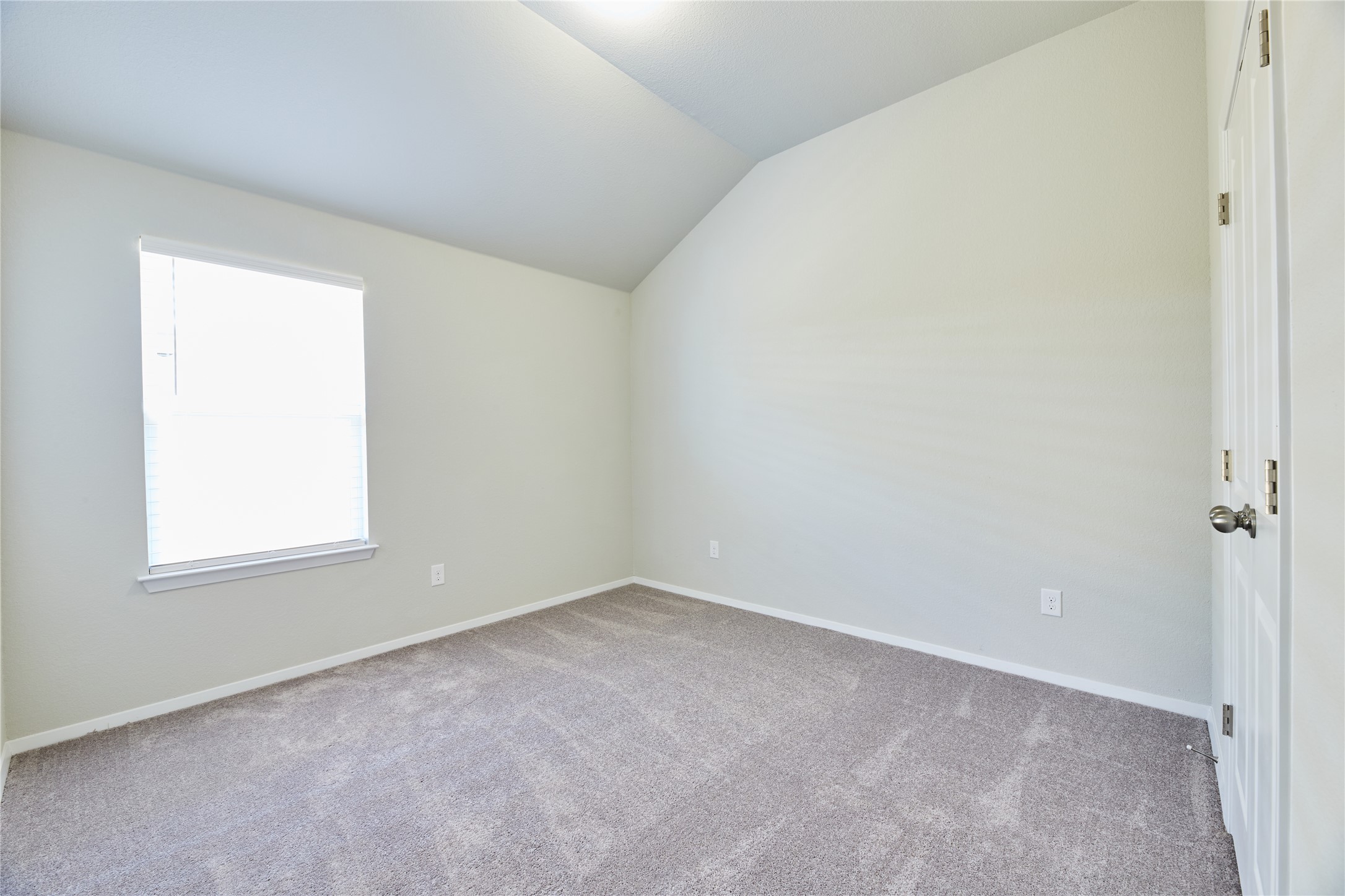303 Trailside Lane Bastrop, TX 78602 - Photo 15 of 25 Unfurnished room with vaulted ceiling and light carpet