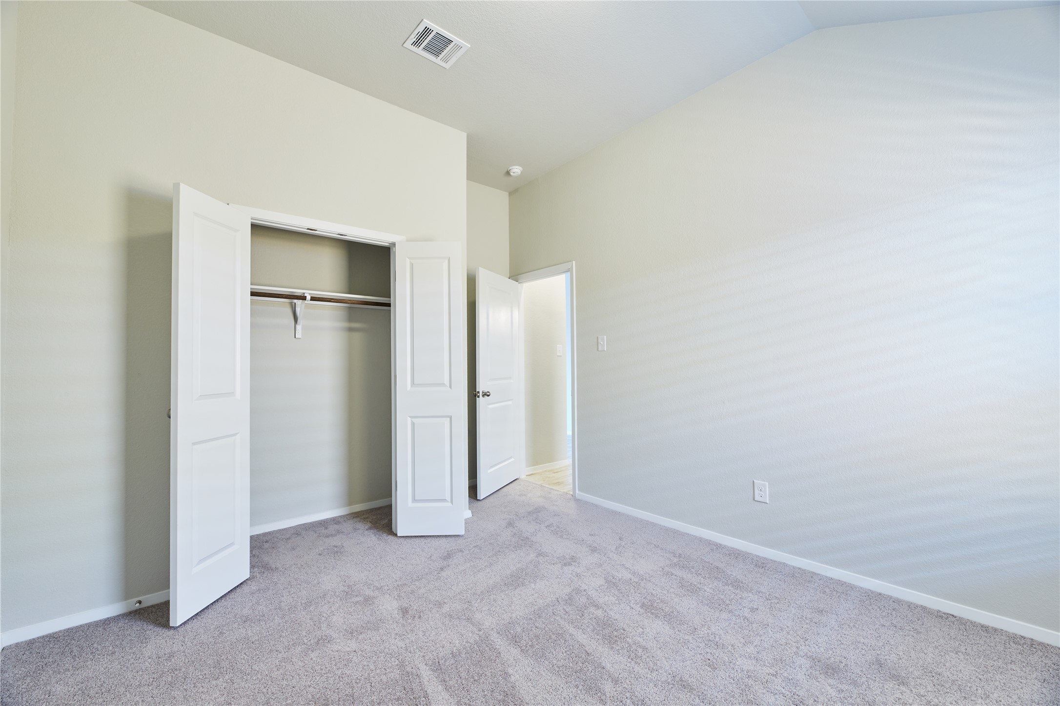 303 Trailside Lane Bastrop, TX 78602 - Photo 16 of 25 Unfurnished bedroom featuring light colored carpet and a closet