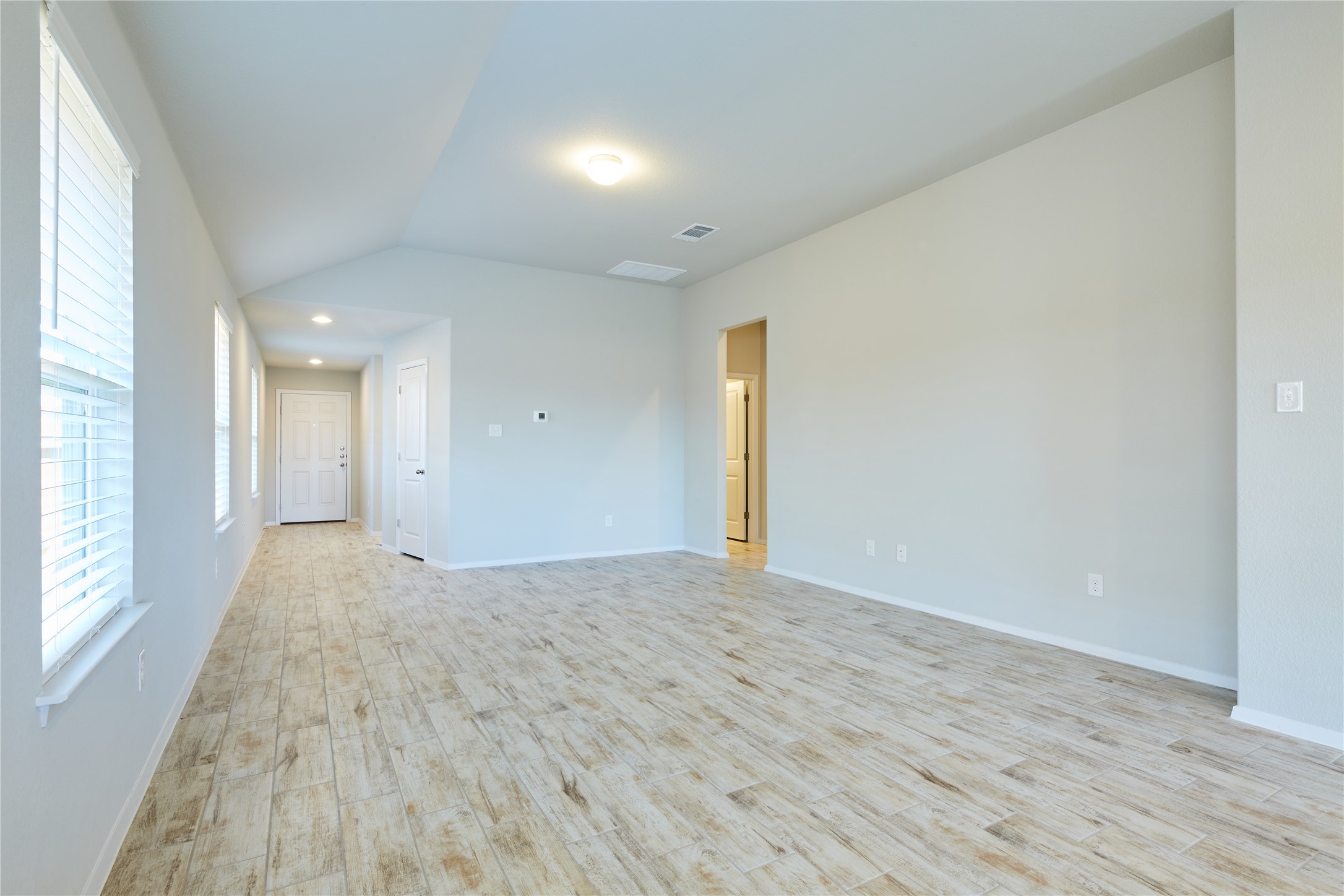 303 Trailside Lane Bastrop, TX 78602 - Photo 4 of 25 Spare room featuring lofted ceiling and light wood-style flooring