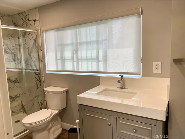 a bathroom with a toilet and shower