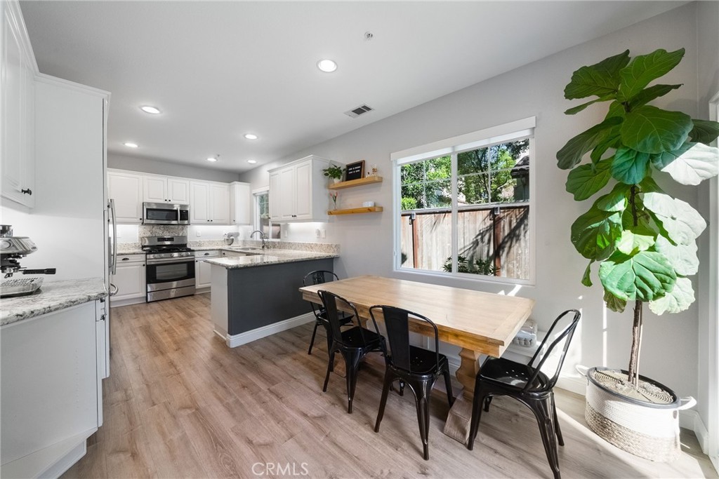 9 Flowerdale Ladera Ranch, CA 92694 - Photo 11 of 54 a kitchen with a table and chairs in it