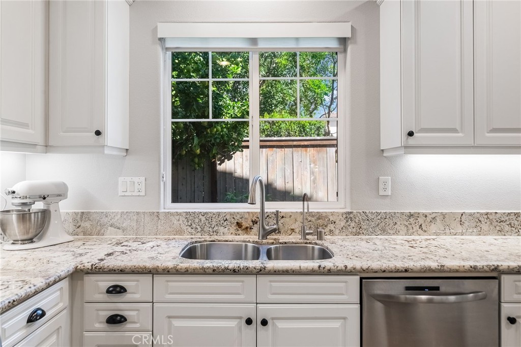 9 Flowerdale Ladera Ranch, CA 92694 - Photo 18 of 54 a kitchen with granite countertop white cabinets and a window