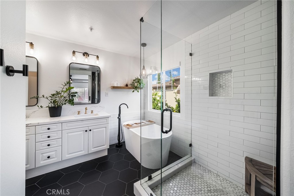9 Flowerdale Ladera Ranch, CA 92694 - Photo 25 of 54 a spacious bathroom with a sink a potted plant and a shower
