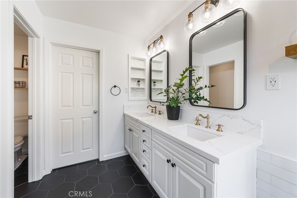 9 Flowerdale Ladera Ranch, CA 92694 - Photo 26 of 54 a bathroom with double vanity sink and a mirror