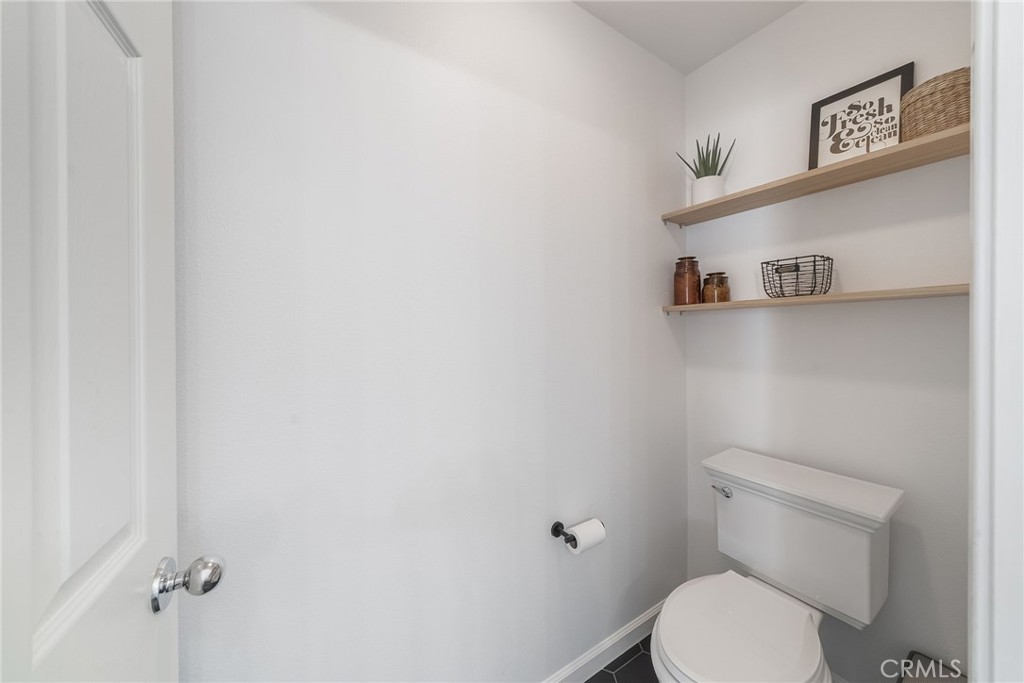 9 Flowerdale Ladera Ranch, CA 92694 - Photo 28 of 54 a white toilet sitting next to a bathroom sink