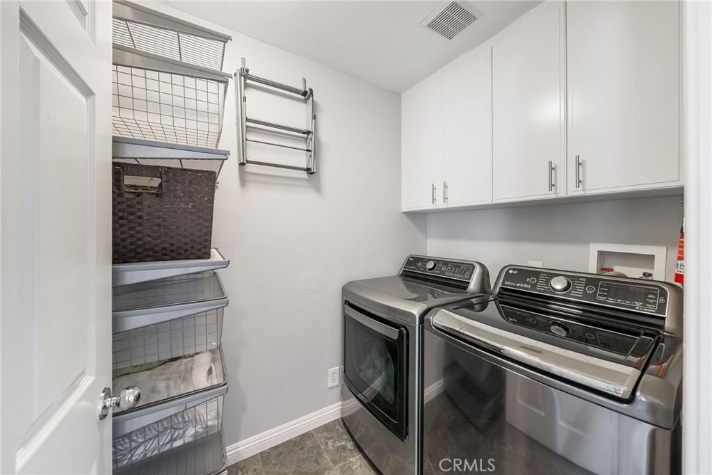 9 Flowerdale Ladera Ranch, CA 92694 - Photo 29 of 54 a kitchen with a stove and white cabinets