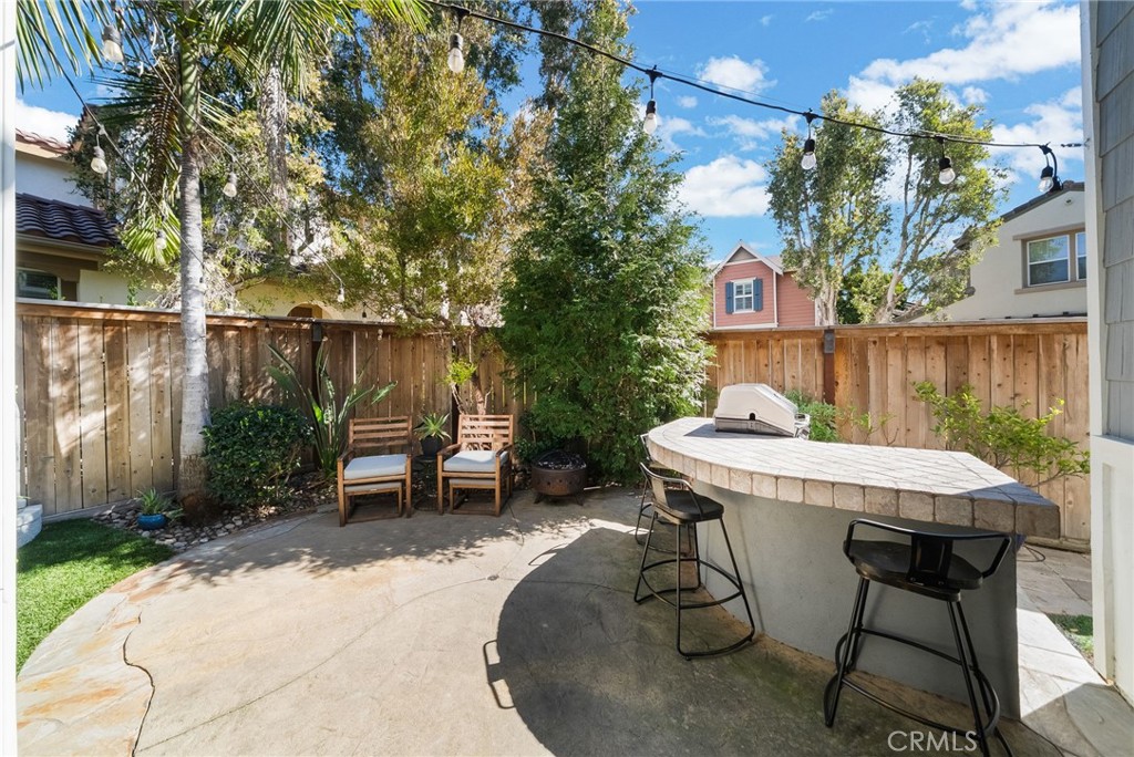 9 Flowerdale Ladera Ranch, CA 92694 - Photo 37 of 54 a view of a table and chairs in back yard of a house