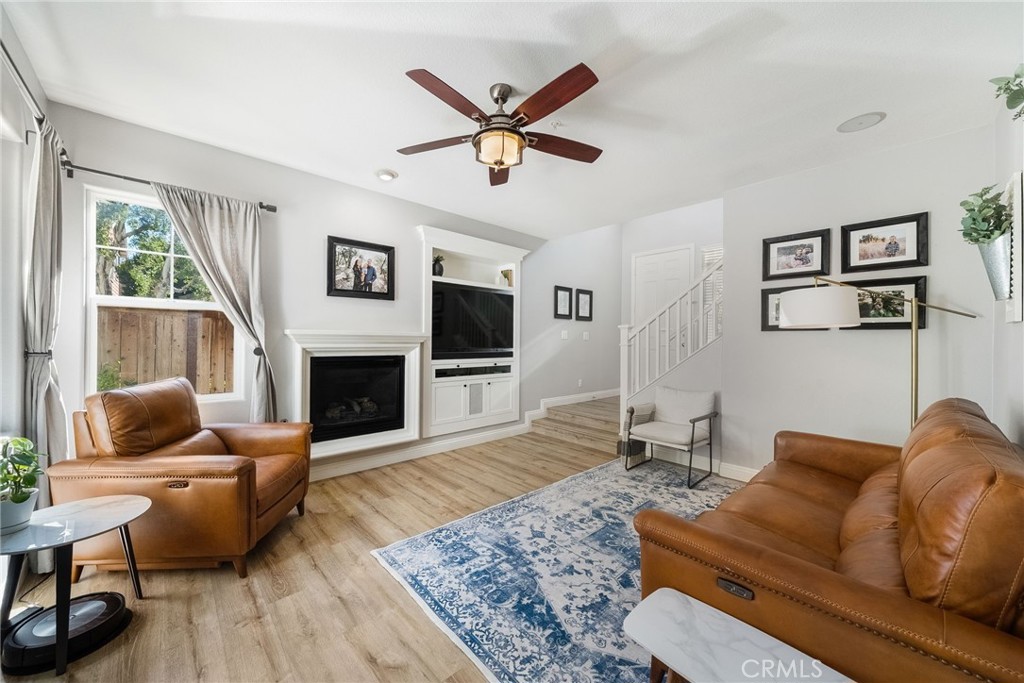 9 Flowerdale Ladera Ranch, CA 92694 - Photo 10 of 54 a living room with furniture a flat screen tv and a fireplace