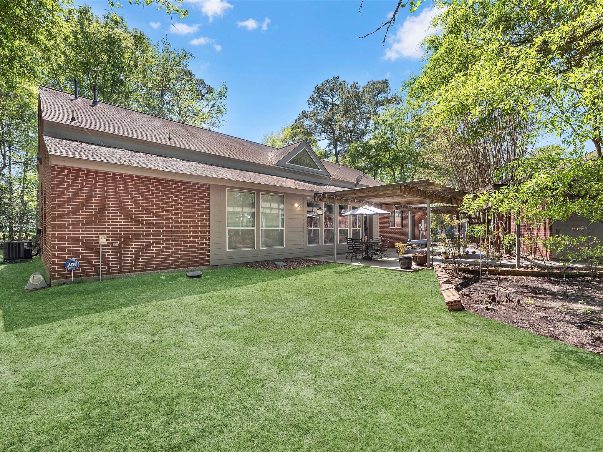 715 Commons Lakeview Drive Huffman, TX 77336 - Photo 39 of 50 a view of a house with backyard and sitting area