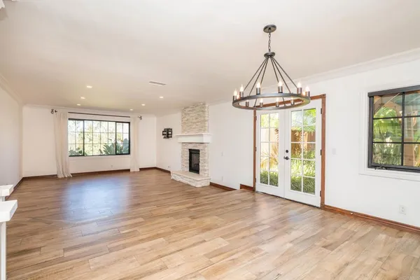 a large kitchen with stainless steel appliances wooden floor and large cabinets