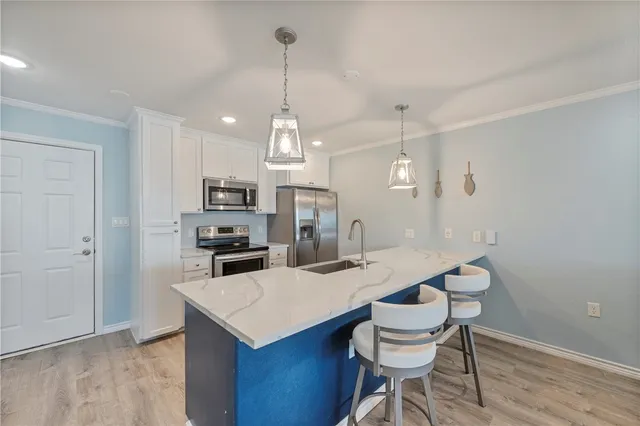 a kitchen that has a table chairs and wooden floor