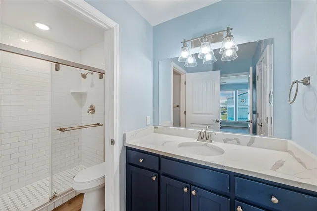 a bathroom with a sink shower and a mirror