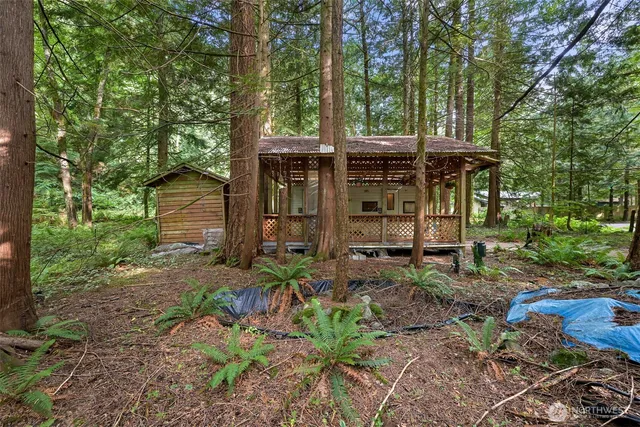 a view of a house with a yard and sitting area