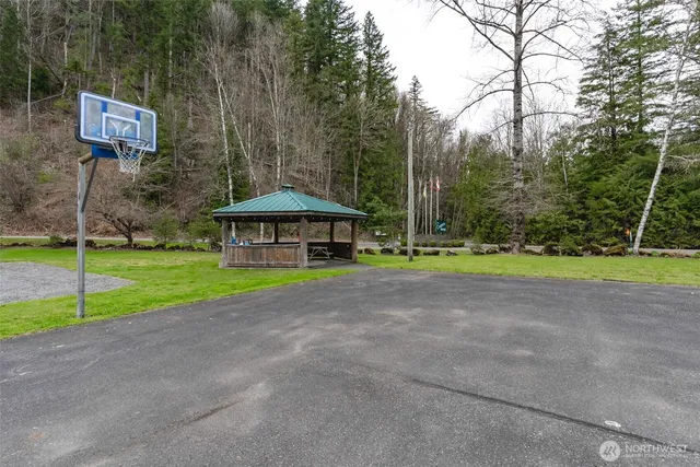 a view of a house with backyard and a parking space