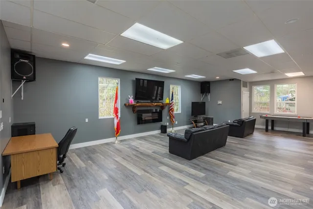 a dining room with stainless steel appliances wooden floor dining table and chairs