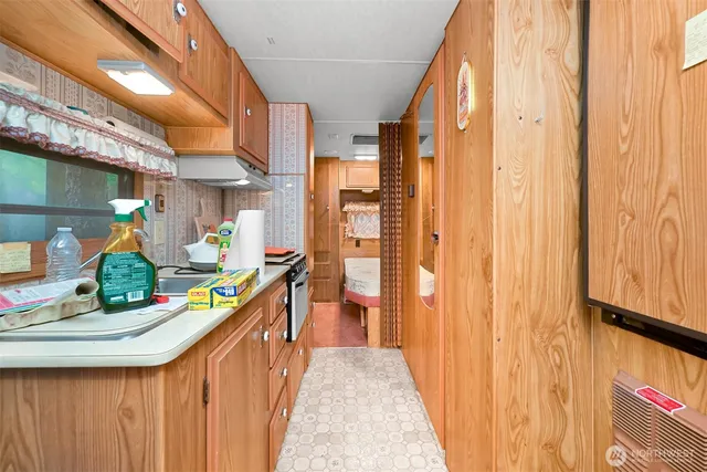 a kitchen with a sink and wooden floor