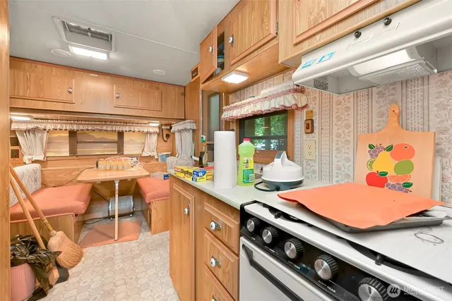 a kitchen with stainless steel appliances kitchen island granite countertop a sink and cabinets