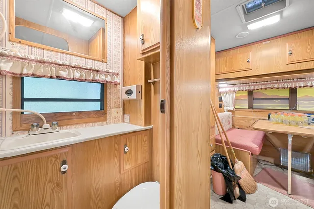 a bathroom with a sink vanity and mirror