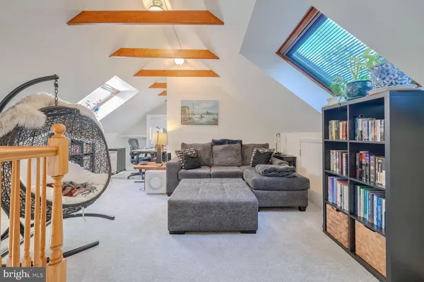 a living room with furniture and a book shelf