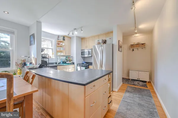 a kitchen with stainless steel appliances a sink stove and cabinets