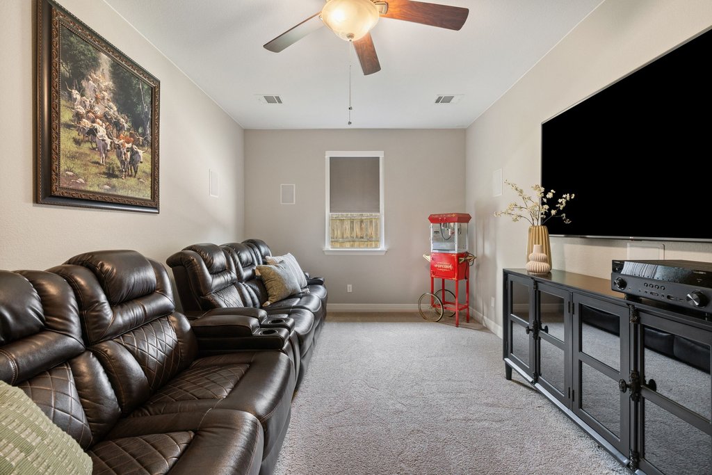 108 Berry Cove Georgetown, TX 78628 - Photo 28 of 39 a living room with furniture and a flat screen tv