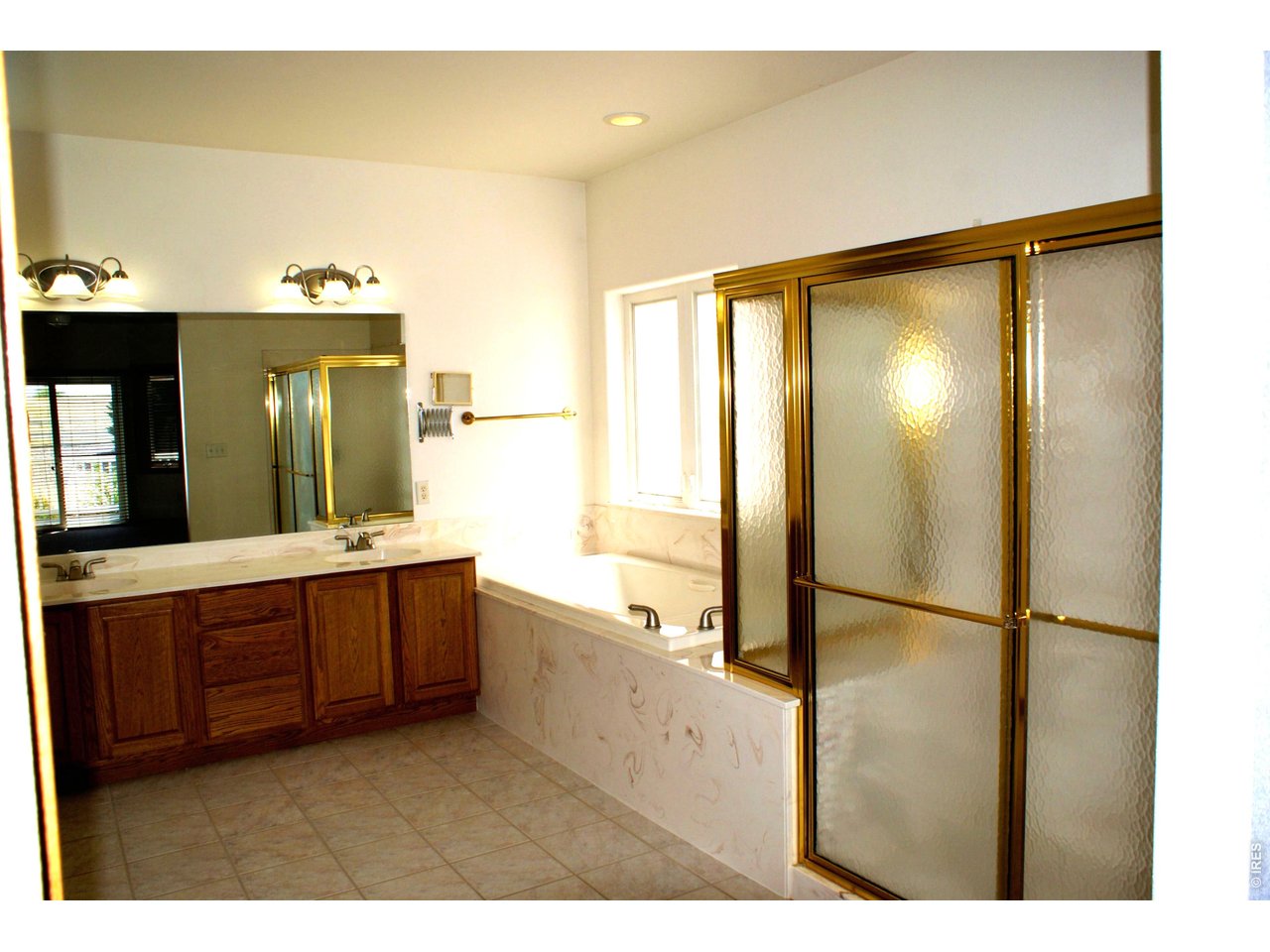 6576 Saddleback Avenue Firestone, CO 80504 - Photo 12 of 25 a bathroom with a granite countertop sink mirror and a bathtub