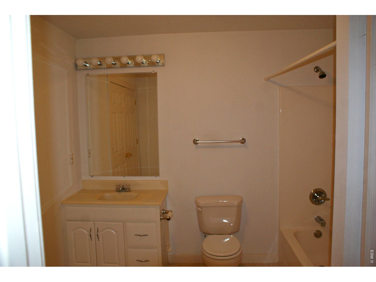 6576 Saddleback Avenue Firestone, CO 80504 - Photo 18 of 25 a bathroom with a granite countertop sink a mirror and a shower