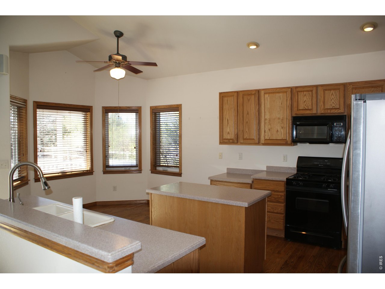 6576 Saddleback Avenue Firestone, CO 80504 - Photo 7 of 25 a kitchen with granite countertop a sink stainless steel appliances and cabinets