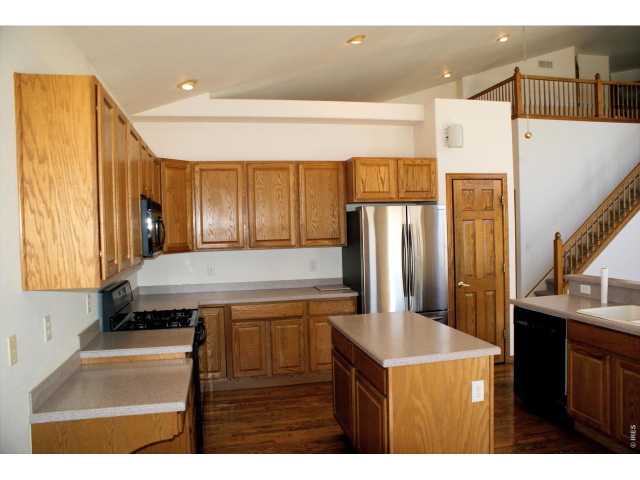 6576 Saddleback Avenue Firestone, CO 80504 - Photo 9 of 25 a kitchen with a refrigerator and a sink