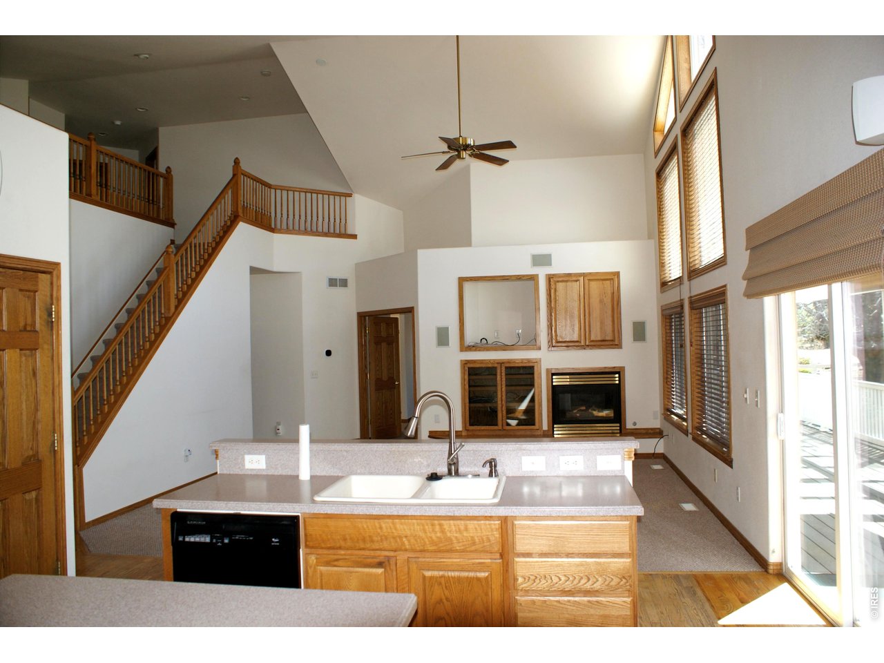 6576 Saddleback Avenue Firestone, CO 80504 - Photo 10 of 25 a kitchen with stainless steel appliances kitchen island granite countertop a sink and cabinets