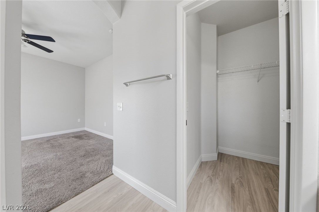6312 Sandy Ridge Street, Unit 3102 North Las Vegas, NV 89081 - Photo 15 of 31 A well-appointed sleeping quarter with soft carpet and ceiling fan, complemented by a spacious walk-in closet.