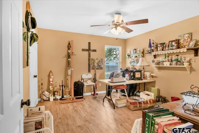 a view of a workspace with furniture and a large window