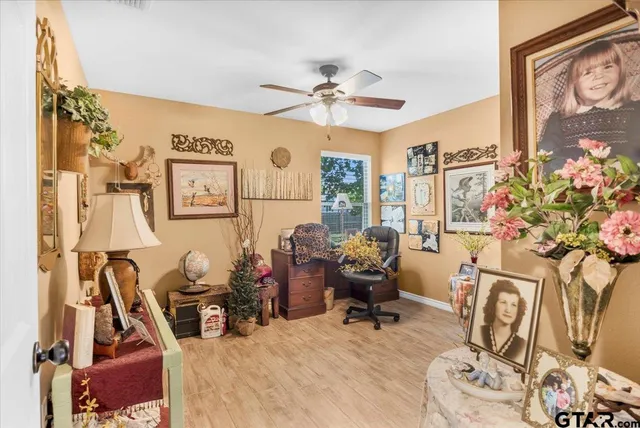 a living room with furniture a chandelier and a flat screen tv