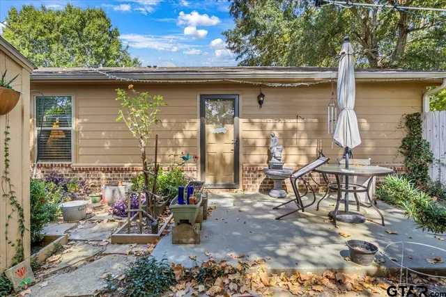 a view of a two chairs in the patio