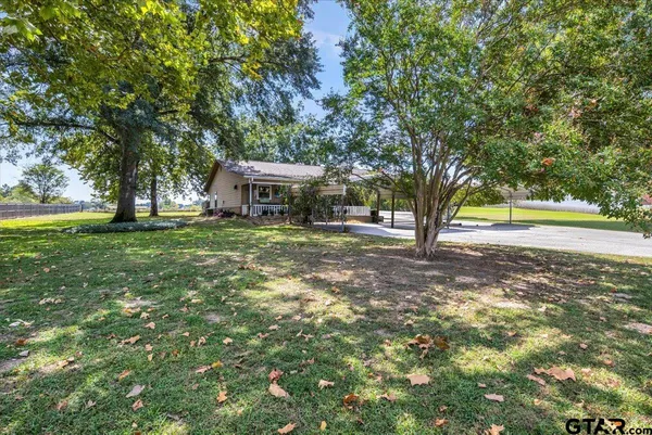 a view of a house with a yard and sitting area