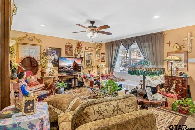a bedroom with furniture and a large window