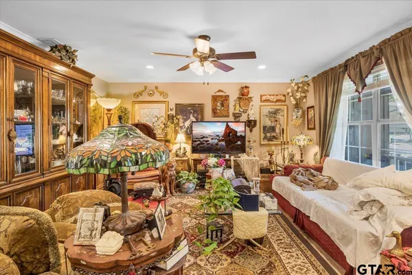 a bedroom with furniture and a large window