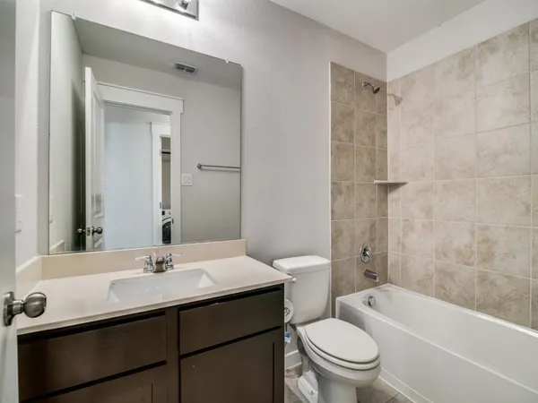 a bathroom with a sink toilet a mirror and shower