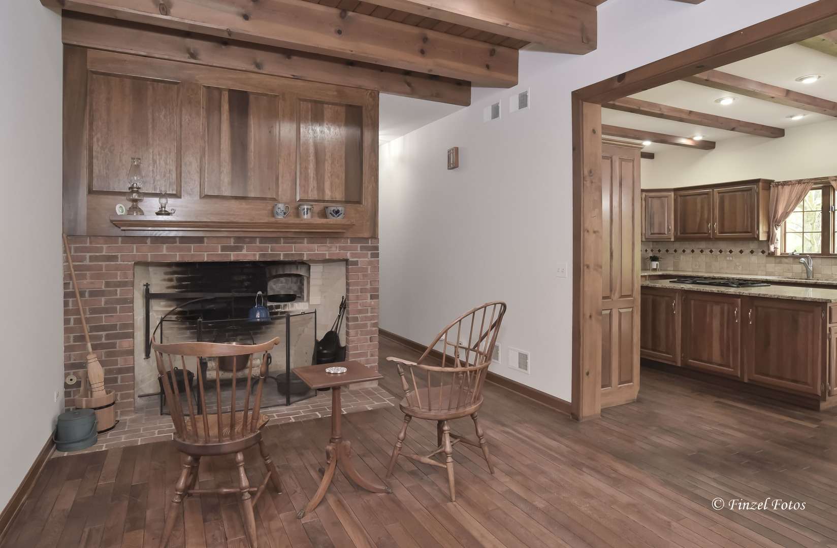 3816 Deep Cut Road Woodstock, IL 60098 - Photo 11 of 32 a kitchen with granite countertop wooden floors and stainless steel appliances