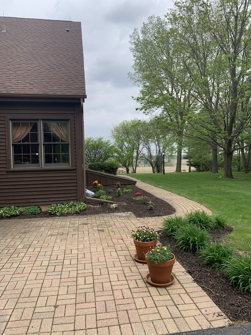 3816 Deep Cut Road Woodstock, IL 60098 - Photo 22 of 32 a front view of a house with a yard