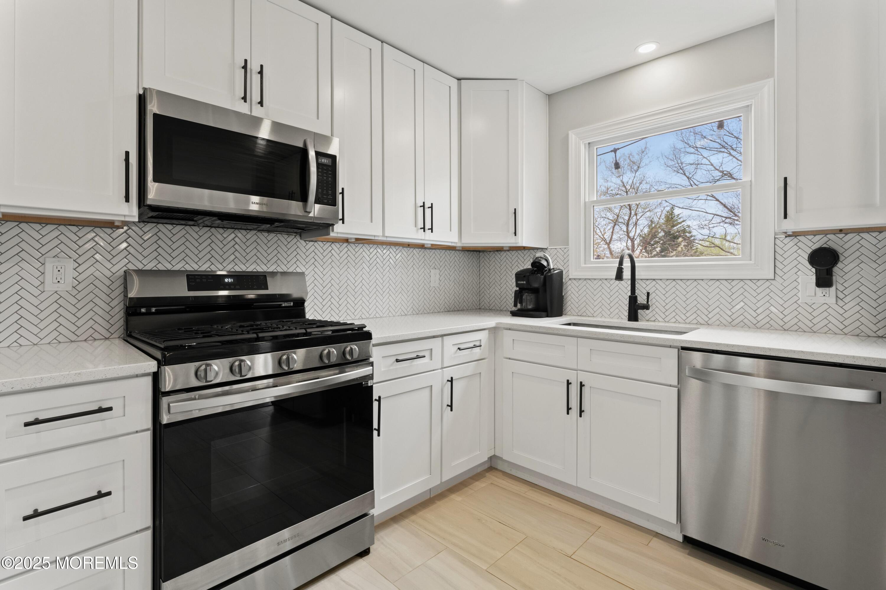 35 Chestnut Hill Road Howell, NJ 07731 - Photo 9 of 30 a kitchen with cabinets stainless steel appliances and wooden floor
