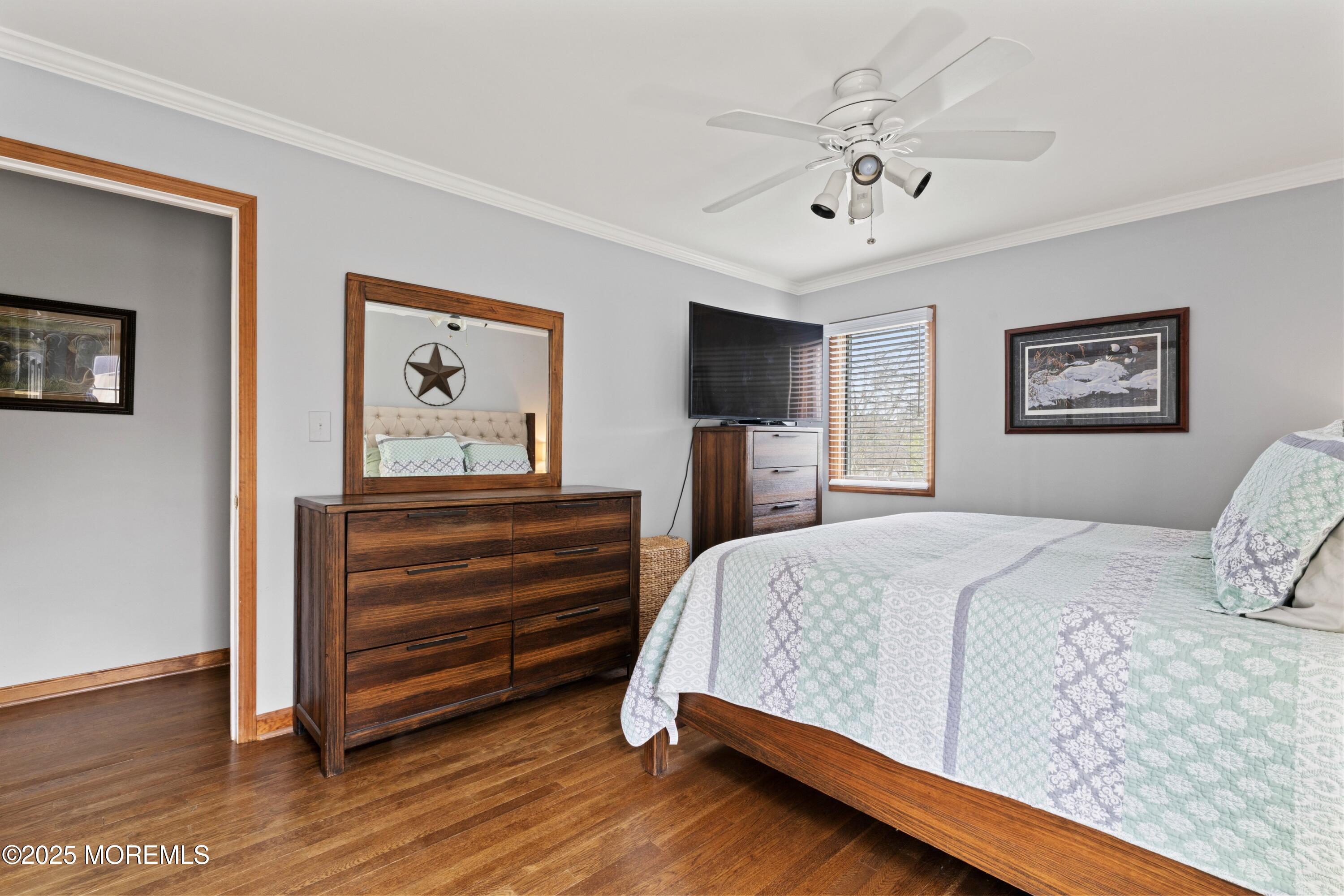 35 Chestnut Hill Road Howell, NJ 07731 - Photo 12 of 30 a bedroom with a bed and a chandelier