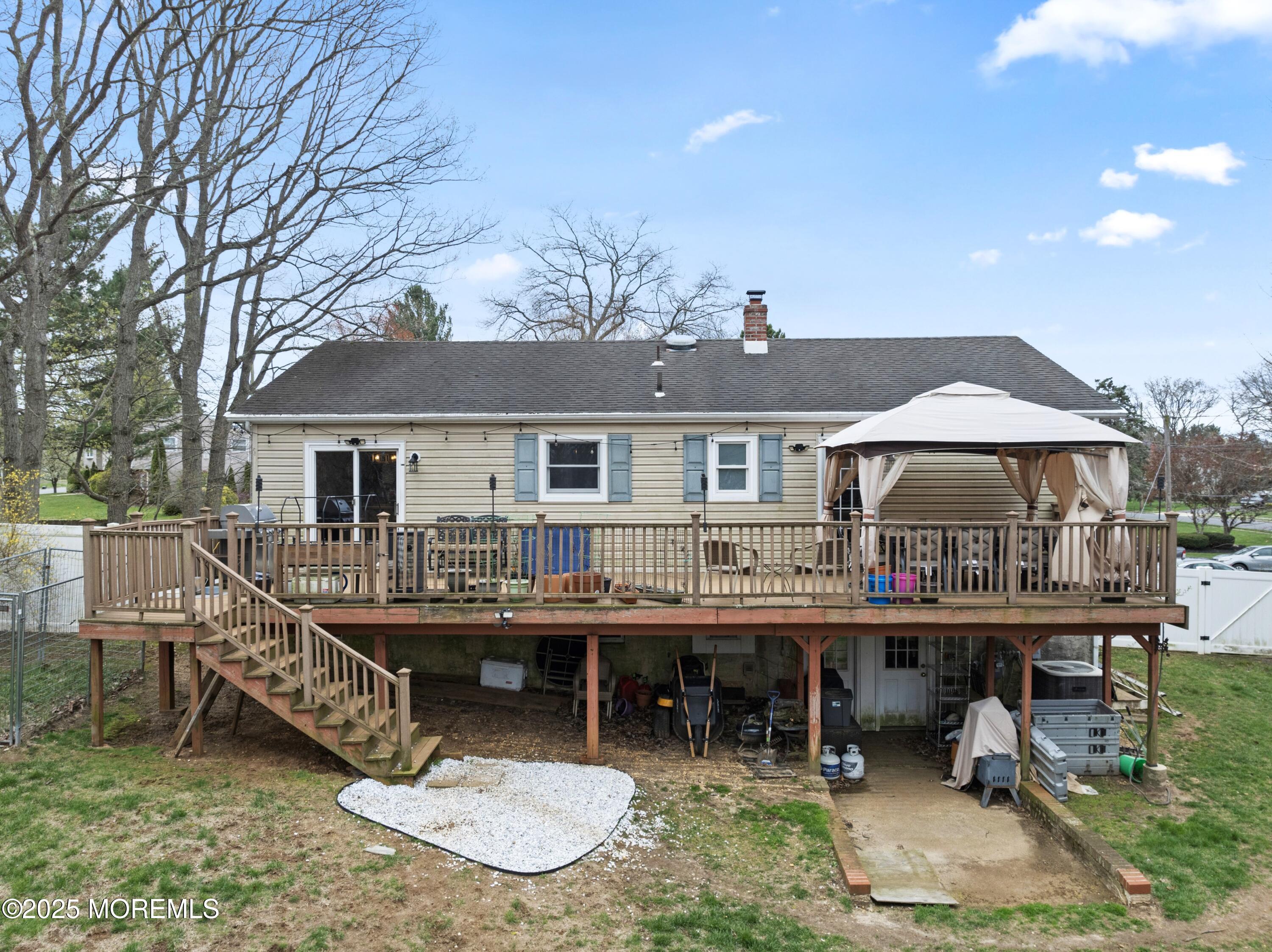 35 Chestnut Hill Road Howell, NJ 07731 - Photo 23 of 30 a roof deck with table and chairs under an umbrella