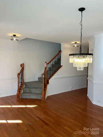 a view of a room with wooden floor and staircase