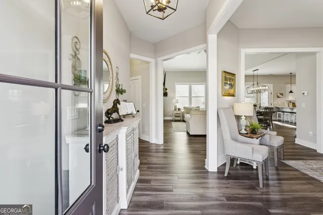a view of a hallway with wooden floor and furniture
