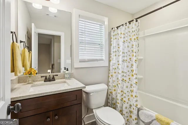 a large bedroom with a bed and a flat screen tv