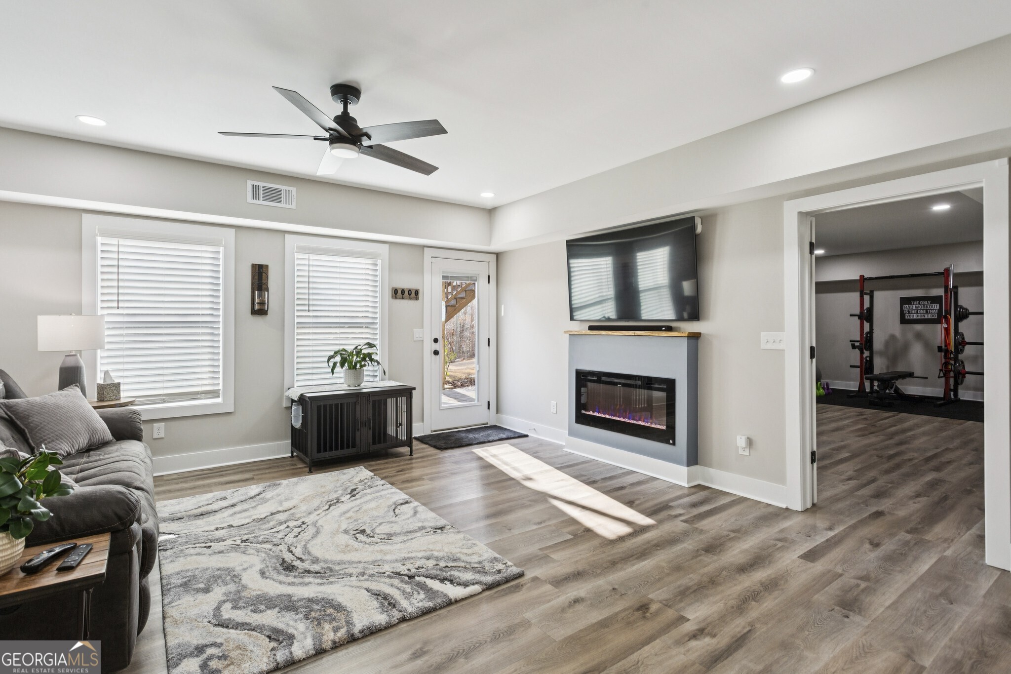 20 Bluestone Way Northeast Cartersville, GA 30121 - Photo 6 of 55 The Fully Finished Basement expands the living space dramatically, offering an additional Living Room with a Fireplace, a Bar Area complete with Sink, Countertop, and Beverage Fridge, plus a Bedroom with Ensuite Bathroom featuring a Large Shower and