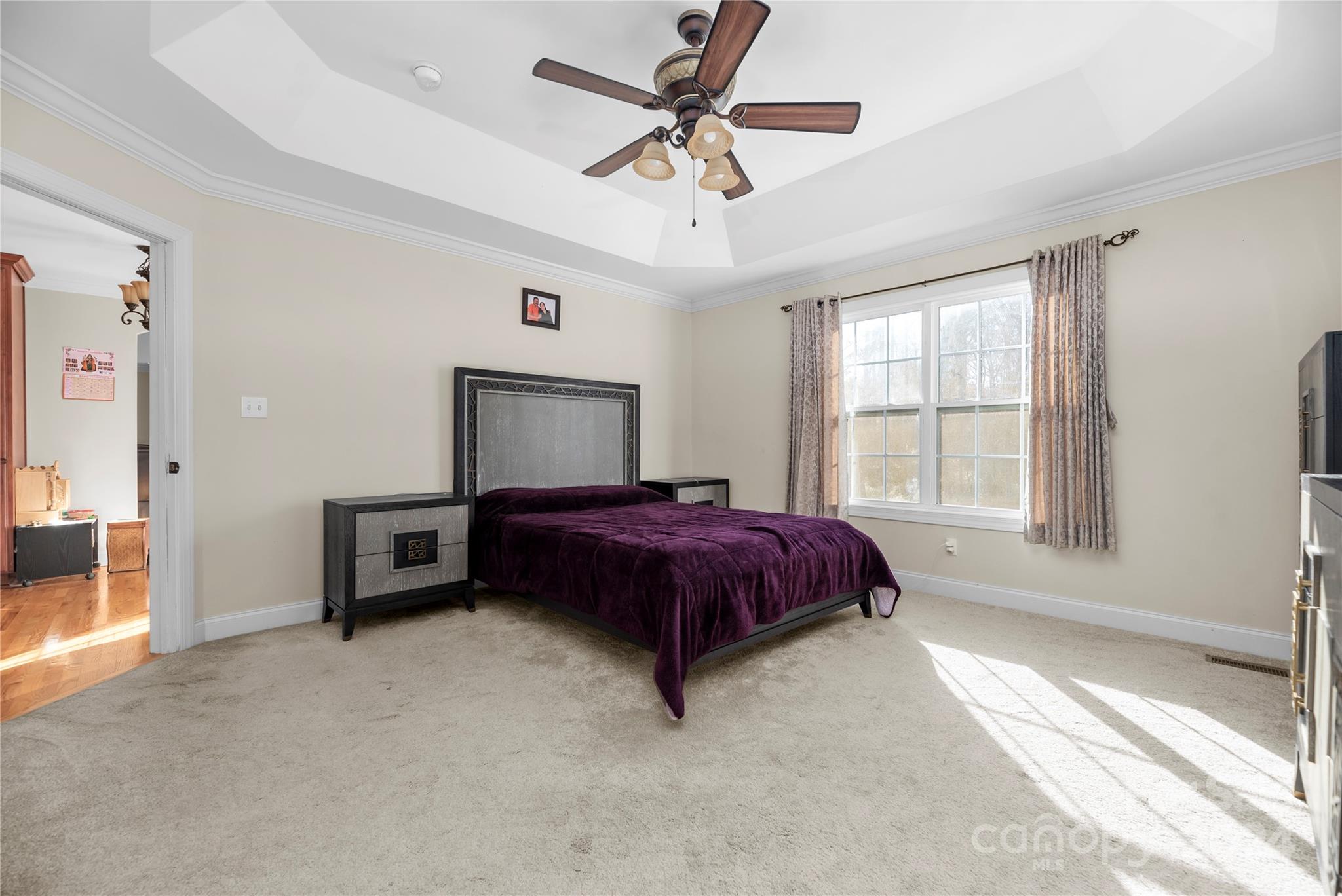 1350 Kensington Circle Newton, NC 28658 - Photo 11 of 45 a spacious bedroom with a bed and a chandelier